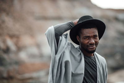 Portrait of young man standing outdoors