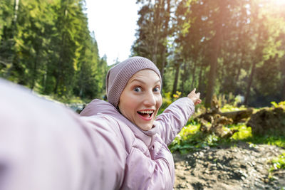 Portrait of smiling young woman in park