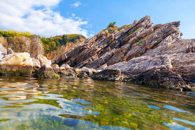 Shale coastline and transparent sea water . idyllic seaside nature with rocks