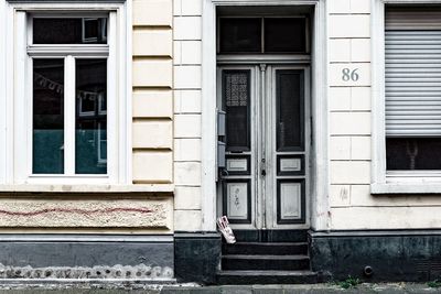 Man standing against door of building