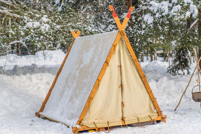 Tent wigwam in winter forest