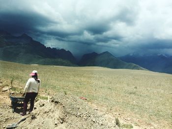 Full length of man on arid landscape against sky