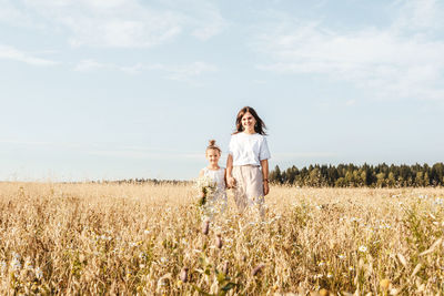 Woman on field against sky