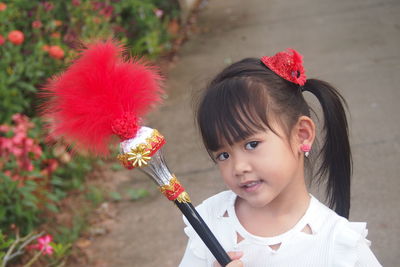 Portrait of girl holding equipment