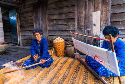 Females working on loom in workshop