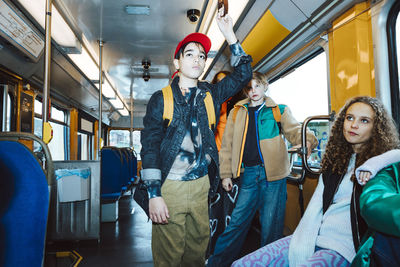 Multiracial boys and girls traveling by tram during weekend