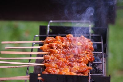 Close-up of satays on barbecue grill