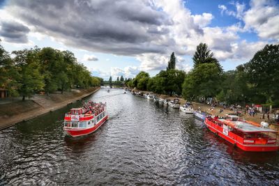 Scenic view of river against sky in city