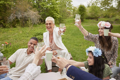 Family raising toast at picnic