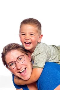 Portrait of happy boy against gray background