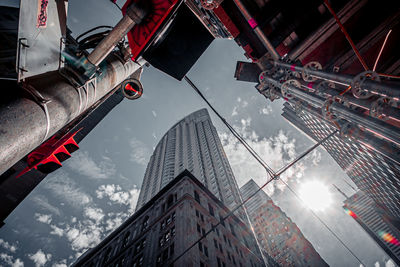 Low angle view of buildings against cloudy sky