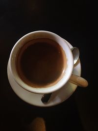 Close-up of coffee cup over black background