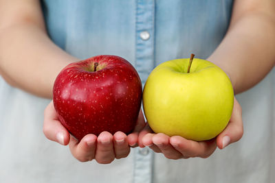 Close-up of hands holding apples