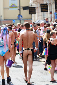 Rear view of people walking on street