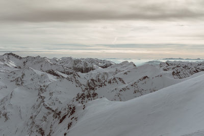 Scenic view of snow covered mountains against sky