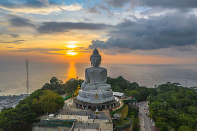 Statue of temple against sky during sunset