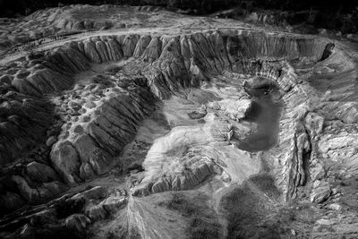 Aerial shot of abandoned opencast mine. abstract cracked mud pattern from a drone. black and white