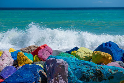Stones colored with rainbow colors on the seashore
