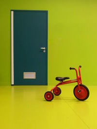 Close-up of tricycle in green room