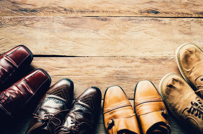 Directly above shot of shoes on hardwood floor