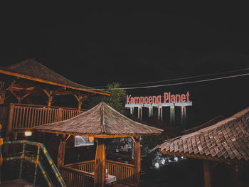 Illuminated building against sky at night