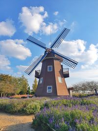 Low angle view of windmill against sky