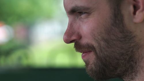 Close-up portrait of young man looking away