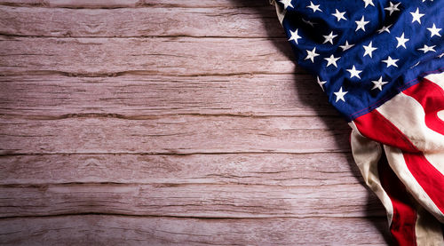 Low angle view of flag against blue wall