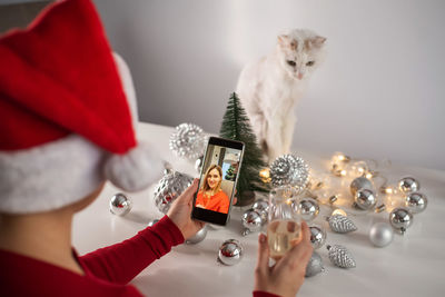 Close-up of woman talking on video call at home