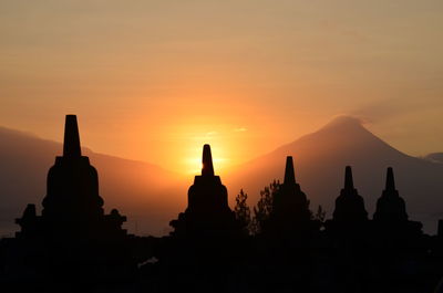 Silhouette temple against sky during sunset