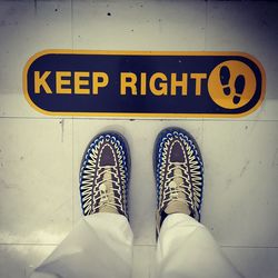 Low section of man standing on tiled floor