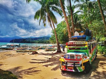 Boats on beach against sky