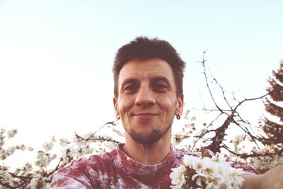 Portrait of young man against sky