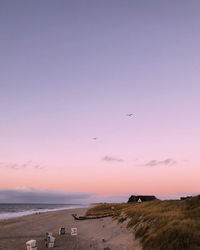 Scenic view of beach against sky during sunset