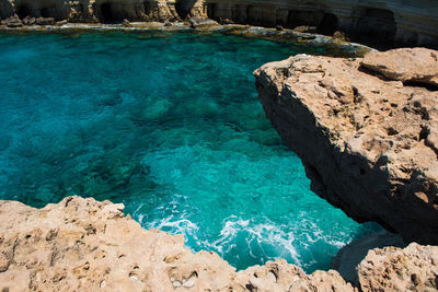 High angle view of rocks by sea