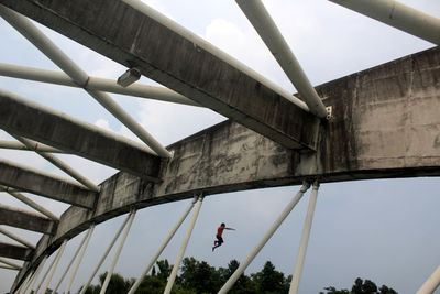 Low angle view of people jump from a bridge