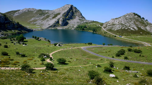 Scenic view of lake and mountains against blue sky