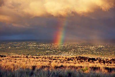 Scenic view of rainbow against sky during sunset