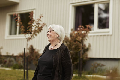 Happy senior woman looking away