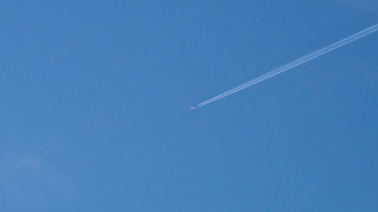 LOW ANGLE VIEW OF AIRPLANE FLYING IN SKY