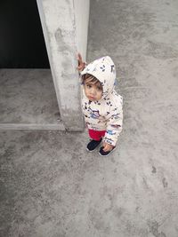High angle view of girl standing with umbrella