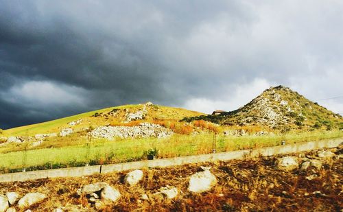 Scenic view of mountains against cloudy sky