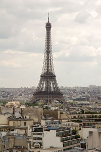 Eiffel tower against cloudy sky