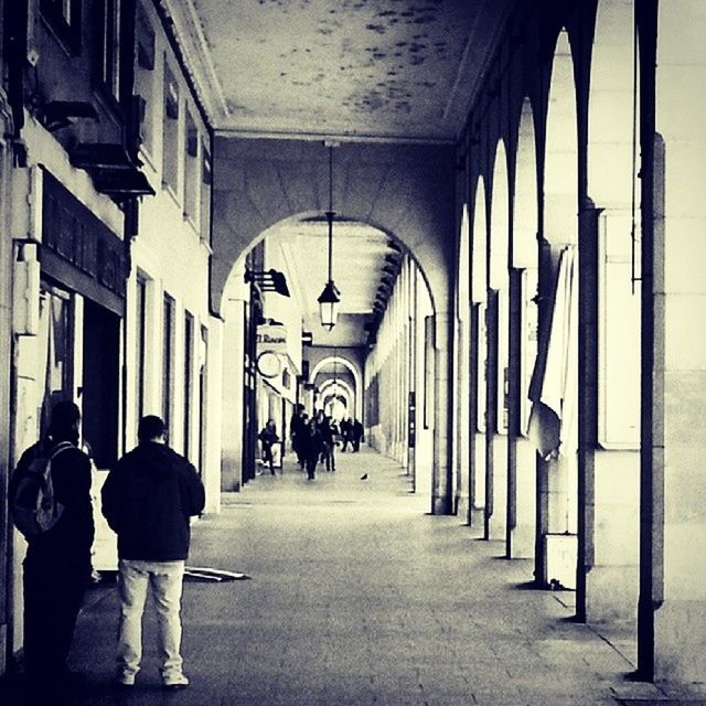 architecture, the way forward, built structure, indoors, walking, arch, men, corridor, rear view, diminishing perspective, full length, lifestyles, building exterior, person, building, narrow, street, vanishing point