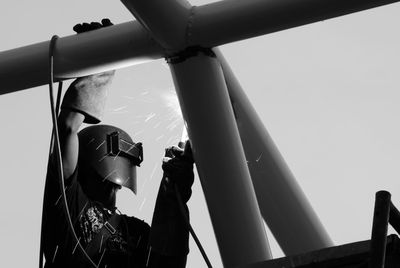 Low angle view of industry worker with welding steel repairing metal