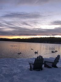 Scenic view of frozen lake against sky during sunset