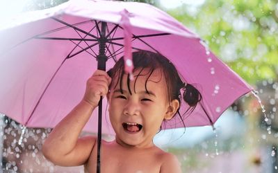 Cute girl with umbrella during rainy season