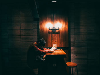 Man holding illuminated lamp