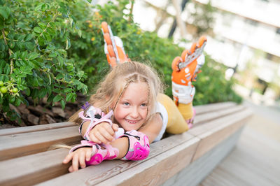 High angle view of cute girl sitting on railing