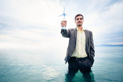 Full length of man standing on shore against sky